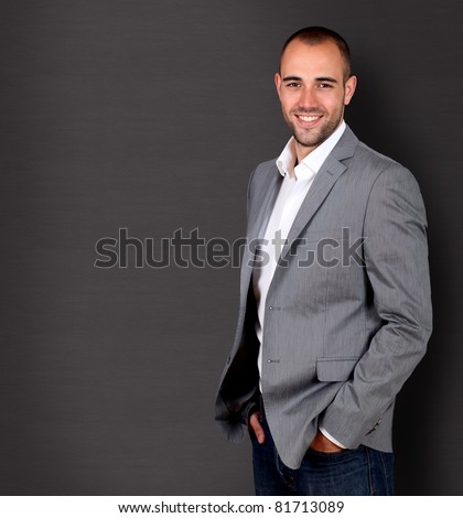 Cool businessman standing on grey background