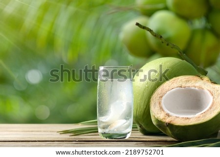 Cool coconut juice with coconut plant background.