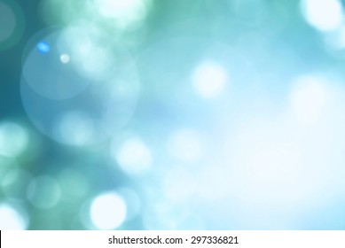 Cool cyan blue green teal color blur sky background with nature glowing sun light flare and bokeh