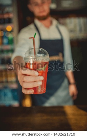 cool drink cocktail in the hands of a waiter