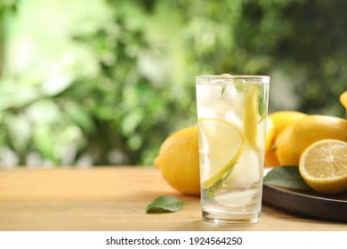 Cool Freshly Made Lemonade And Fruits On Wooden Table. Space For Text