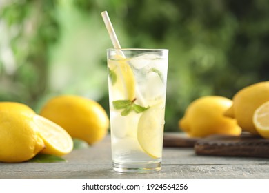 Cool freshly made lemonade and fruits on grey wooden table