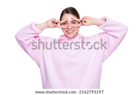 cool funny young girl in pink hoodie isolated on white background. peace