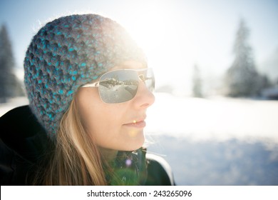 Cool Girl With Cap Looking  To Winter Landscape Through Sunglasses