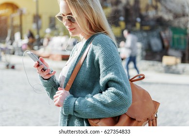 Cool Girl Using Phone For Musical Entertainment