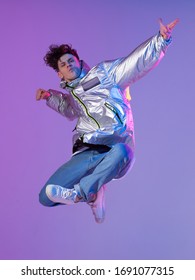 Cool Guy Dancing Contemporary Dance In Studio. Neon Light Background. Acrobatic Bboy Dancer. Break Dance Lessons.