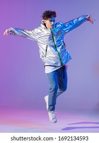 Cool Guy Dancing Contemporary Dance In Studio. Neon Light Background. Acrobatic Bboy Dancer. Break Dance Lessons.