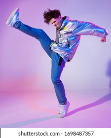 Cool Guy Dancing Contemporary Dance In Studio. Neon Light Background. Acrobatic Bboy Dancer. Break Dance Lessons.