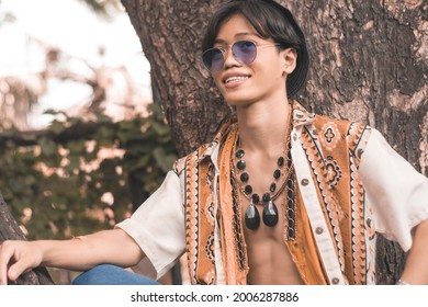 A Cool Hippie Dude Hanging Out By A Tree. Outdoor Scene At The Park.