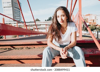 Cool Hipster African Young Girl With Curly Hair, Street Hip Hop Style, Looking Serious Defiant To Camera, Dynamics And Expression. Copy Space, Social Network Concept. White Tshirt Denim Jeans