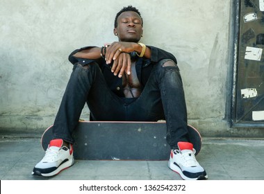 Cool Isolated Portrait Of Young Attractive And Confident Hipster Black Afro American Man Leaning On Street Wall Holding Skate Board As Badass Guy In Urban Style Concept