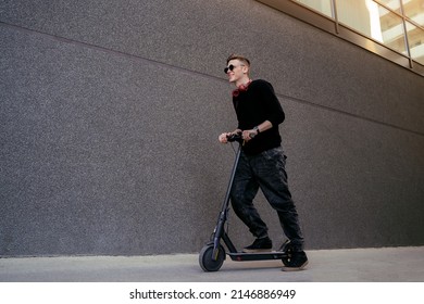 Cool Millennial Guy On E Scooter Driving Through The City 