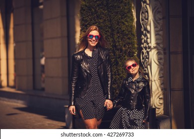 Cool Mom And Daughter In City. Fashion Clothes