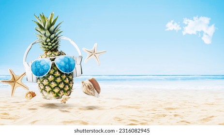 Cool pineapple wearing headphones and partying at the tropical beach, summer vacations and music concept - Powered by Shutterstock