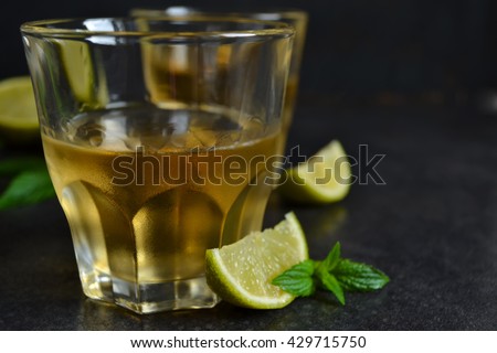 cool rum iced lime and mint on black background  