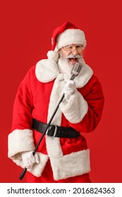 Cool Santa Claus With Microphone Singing Christmas Song On Color Background