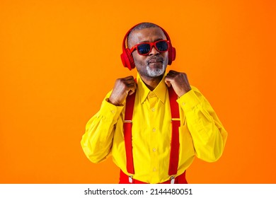 Cool senior man with fashionable clothing style portrait on colored background - Funny old male pensioner with eccentric style having fun - Shutterstock ID 2144480051
