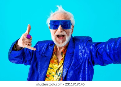 Cool senior man with fashionable clothing style portrait on colored background - Funny old male pensioner with eccentric style having fun - Powered by Shutterstock