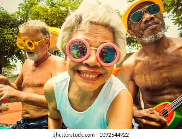 Cool Seniors Acting Youtful By A Swimming Pool