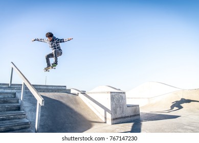 Cool Skateboarder Outdoors - Afroamerican Guy Jumping With His Skate And Performing A Trick