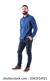 Cool Smiling Guy, With Hands In Pockets Looking Up Wearing Blue Denim Shirt And Pants. Full Body Isolated On White Background.