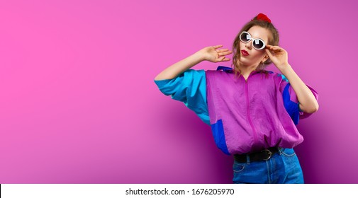 Cool teenager  Fashionable DJ girl in colorful trendy jacket   vintage retro sunglasses enjoys style 80s    90s vibes  Teenager Girl at disco party  Young fashion model pink color background 