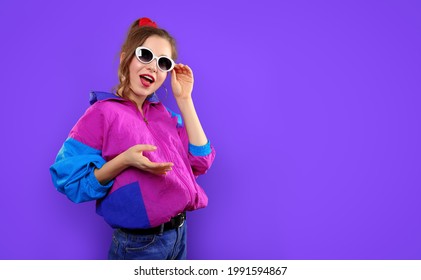 Cool Teenager. Fashionable DJ Girl In Colorful Trendy Jacket And Vintage Retro Sunglasses Enjoys Style Of 80s - 90s Vibes. Teenager Girl At Disco Party. Young Fashion Model On Pink Color Background.