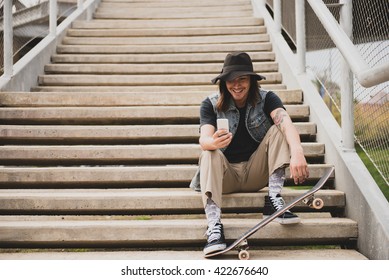 Cool Urban Skater Guy At The Stairs Using His Smart Phone