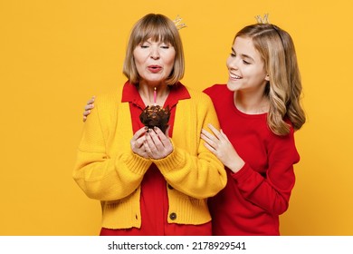 Cool Woman 50s In Red Shirt Crown Have Fun With Teenager Girl 12-13 Years Old Grandmother Granddaughter Hold Birthday Cake Blow Out Candle Isolated On Plain Yellow Background Family Lifestyle Concept