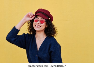 Cool woman with curly hair, hat and sunglasses posing - Shutterstock ID 2278101827