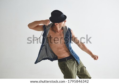 Cool young guy breakdancer in hat dancing hip-hop in studio isolated on white background. Dance school poster