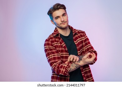 Cool Young Handsome Businessman Model Guy With Fashion Haircut In Trendy Vintage Clothes With Stylish Shirt Rolls Up Sleeves In The Colorful Studio. Male Portrait Of Professional Artist 