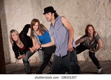 Cool young Hispanic dancer with group in underground setting - Powered by Shutterstock