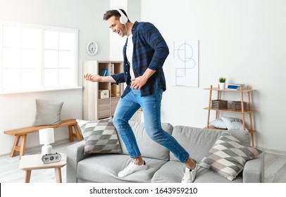 Cool Young Man Dancing And Listening To Music At Home