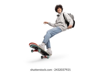 Cool young man with headphones and backpack riding a skateboard isolated on white background     - Powered by Shutterstock
