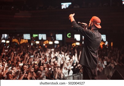 Cool Young Rap Singer Performing On Concert Stage. White Hip Hop Artist With Microphone In Hand Singing On Music Festival In Nightclub. EUROPE - 1 MAY,2022