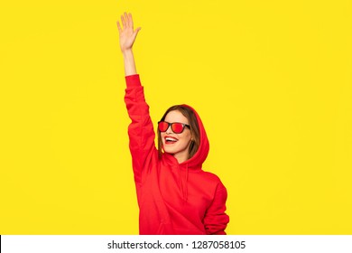 Cool Young Woman In Red Hoodie Saluting Someone