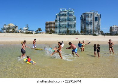 COOLANGATTA - OCT 07 2014:Family Having Fun In Coolangatta Beach.Coolangatta Was One Of The Earliest Settlements On The Gold Coast Today It's A Very Popular Tourist Destination In Australia.