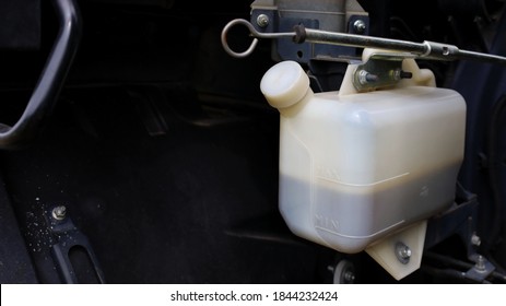 Coolant Tank White. Plastic Car Coolant Container In Truck Radiator System On Dark Background With Copy Space. Auto Parts Concept. Close Focus And Select An Object