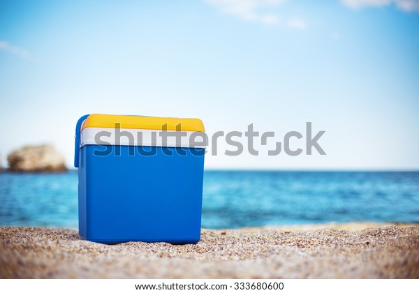 Cooler box on the sea\
sand