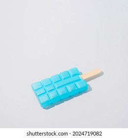 Cooler Pack Cyan Blue Popsicle Against Gray Background. Retro Aesthetic Minimal Still Life. Surreal Art Summer Food Concept.