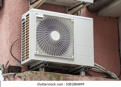 Cooling Fan Air Conditioner on red wall background - Shutterstock ID 1081884899