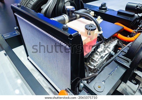 Cooling radiator in car. Car manufacturing.\
Concept - replacement of filters in radiator. Process of assembling\
car at enterprise. Radiator cooling inside track. Cooling of\
automobile engine.
