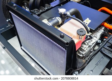 Cooling radiator inside car. Car radiator inside dismantled bonnet. Inside car. Concept - filter replacement. Installing new cooling filter. Engine cooling system repair. Car repair.