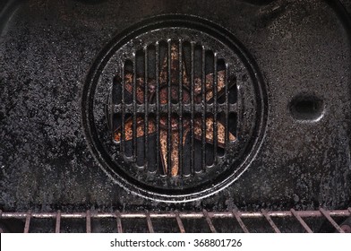 the cooling system inside the oven, covered with grease and soot, closeup
