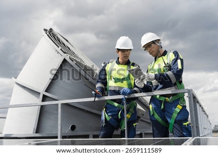 Cooling tower. Engineer or technicians maintenance and repair of cooling towers on rooftop of building