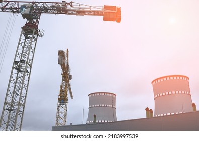 Cooling tower of an environmentally friendly nuclear power plant under construction and a lifting tower crane