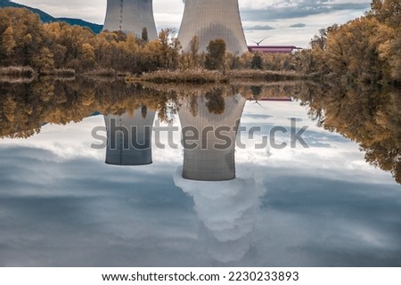 Cooling Towers of Cruas Nuclear Power Plant with Dramatic Clouds of Smoke Reflected in the LakeFrance Europe Nuclear power Industry 