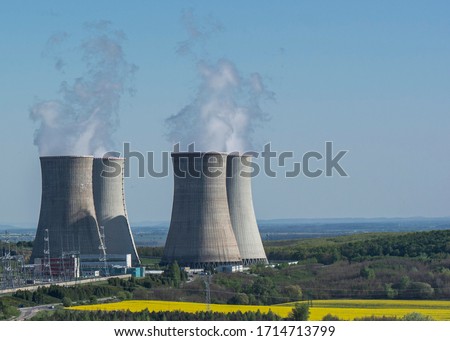 Cooling towers of nuclear power plant Mochovce with the yellow field of rapeseed in front of them.
