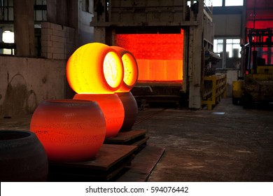 Cooling-off Period Of Some Forged Steel Hollow Balls In A Forge Environment. Furnace In The Background.